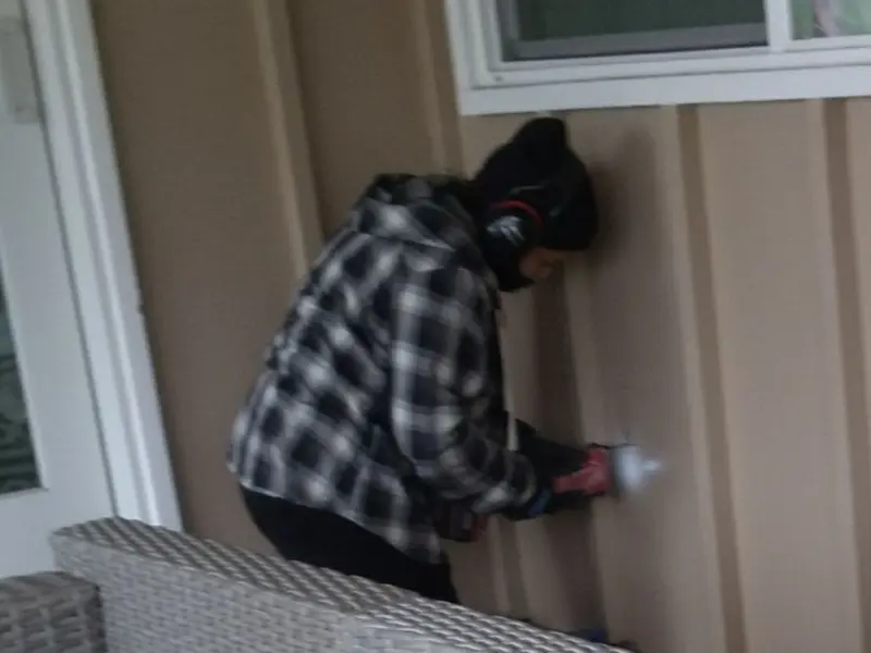 Professional electrician installing an exterior outlet in Crosspointe
